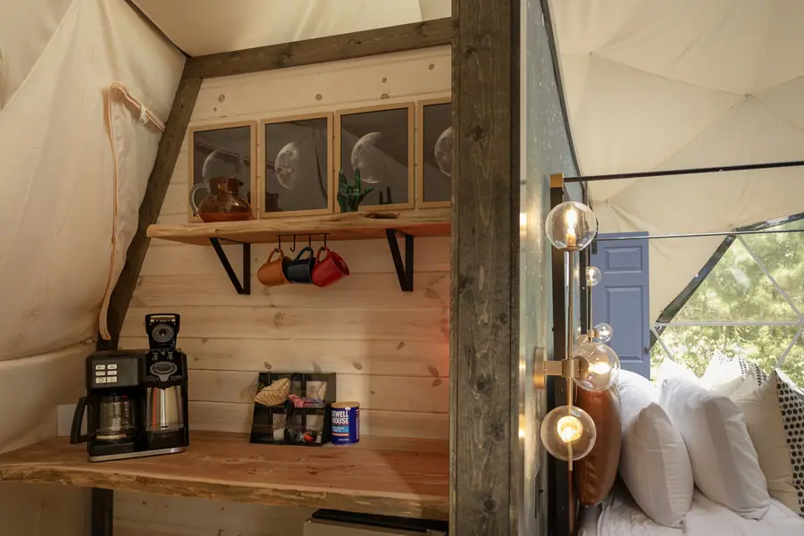 Coffee station with mugs and shelves inside the dome