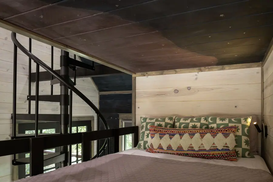 Full-over-full bunk beds by the spiral staircase in the game room