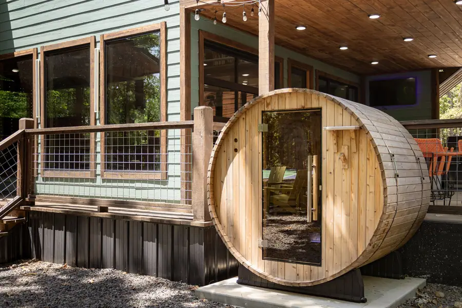 Cedar barrel sauna beside the cabin deck