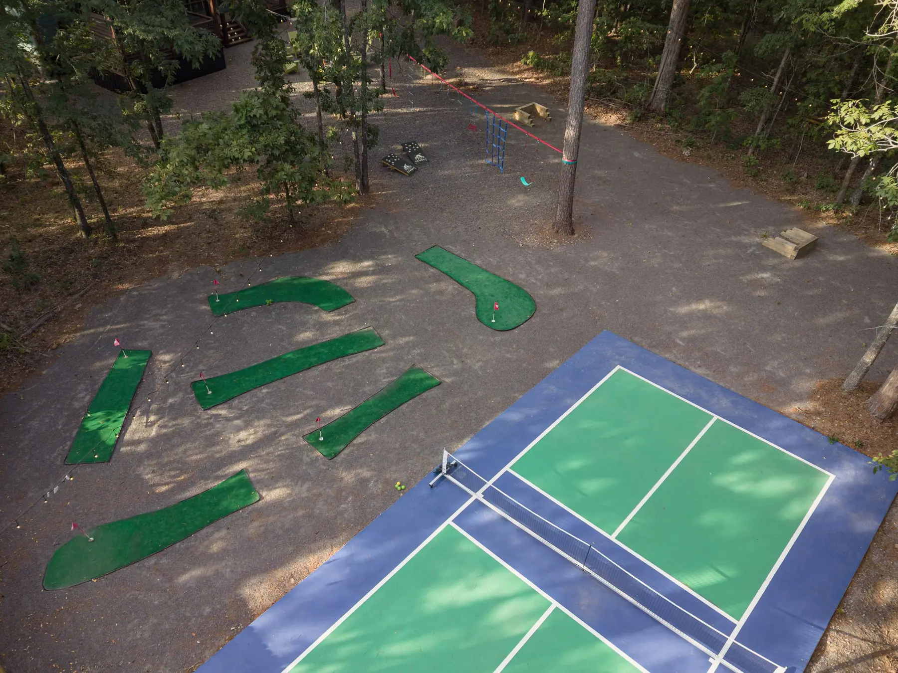 Aerial view of the private pickleball court and putt-putt course in the trees